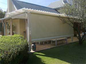 Roller blind fitted to pergola structure